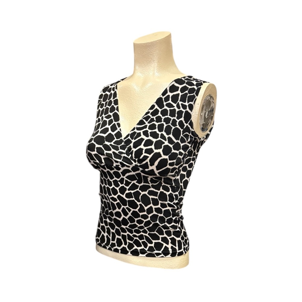 Black and White low cut sleeveless blouse with bold pattern.